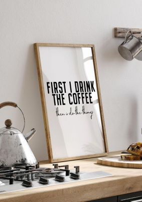 An unframed print of first i drink the coffee quote in typography in white and black accent colour