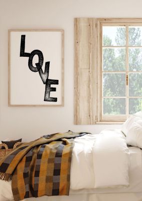 An unframed print of love in typography in white and black accent colour
