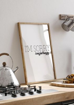An unframed print of sorry i was hungry funny slogans in typography in white and black accent colour