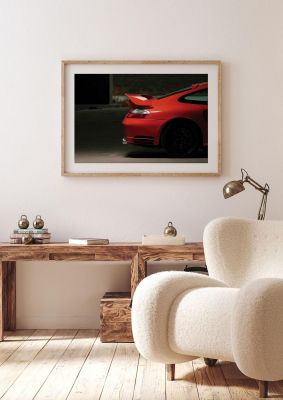 An unframed print of porsche rear sports photograph in grey and red accent colour