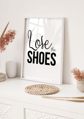 An unframed print of lose the shoes quote in typography in white and black accent colour