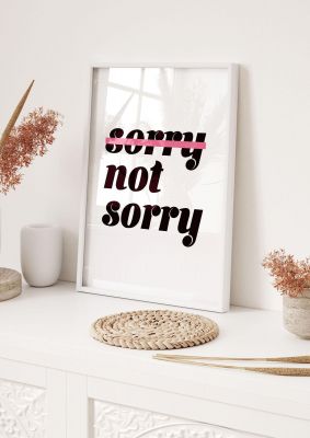 An unframed print of sorry not sorry funny slogans in typography in white and black accent colour
