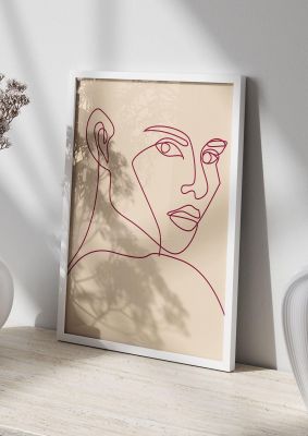 An unframed print of line drawing red on ecru graphical in beige and red accent colour