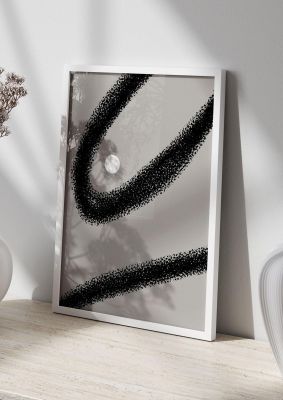An unframed print of abstract black shape graphical in grey and black accent colour