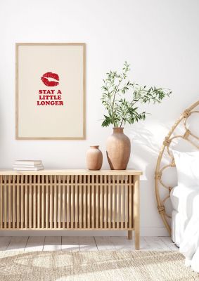 An unframed print of stay a little longer typographic funny slogans in typography in beige and red accent colour