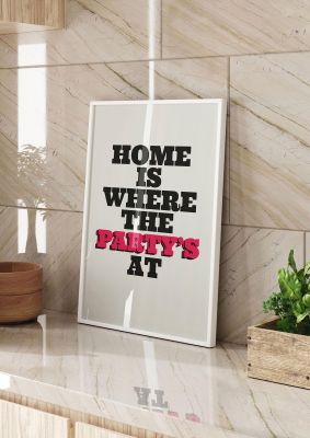 An unframed print of home is where the partys at quote funny slogans in typography in beige and red accent colour