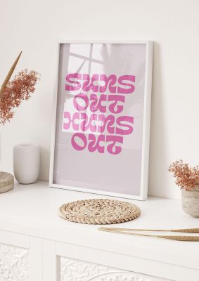 An unframed print of suns out huns out quote in typography in pink and beige accent colour