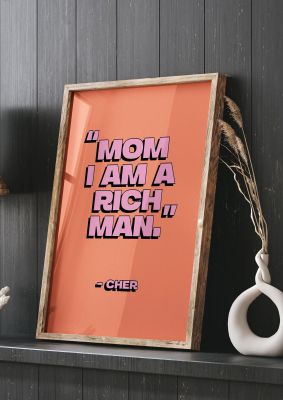 An unframed print of cher rich man quote in typography in pink and peach accent colour