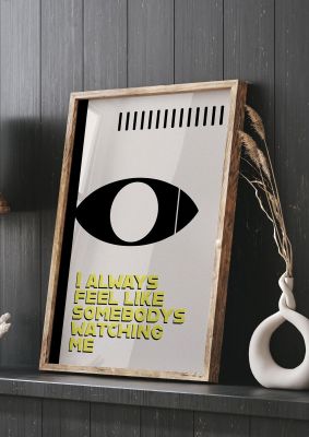 An unframed print of somebodys watching me lyric music graphic in beige and yellow accent colour