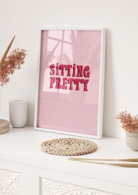 An unframed print of pink sitting pretty quote in typography in pink and red accent colour