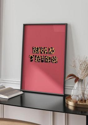 An unframed print of wild thing animal lyric graphical in typography in pink and orange accent colour