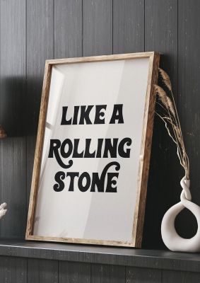 An unframed print of rolling stone bob dylan lyric music in typography in beige and black accent colour