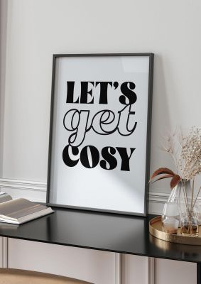 An unframed print of lets get cosy black white funny slogans in typography in grey and black accent colour