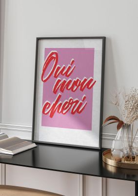 An unframed print of oui mon cheri yes dear go on funny slogans in typography in pink and red accent colour