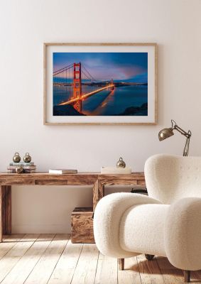 An unframed print of golden gate bridge at night san francisco travel photograph in blue and red accent colour