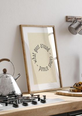 An unframed print of what goes around quote in typography in beige and black accent colour