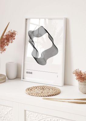 An unframed print of liquid shapes one monochrome abstract in white and silver accent colour