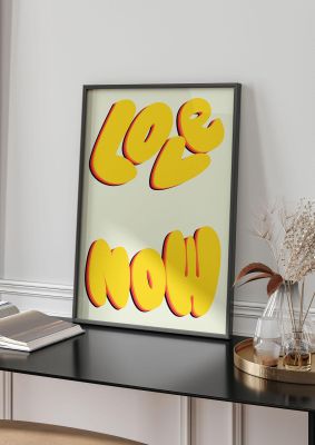 An unframed print of love now ecru graphical in typography in yellow and yellow accent colour