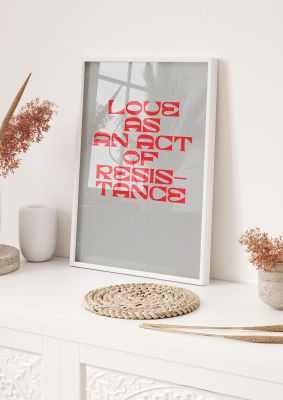 An unframed print of love as an act of resistance red in typography in grey and red accent colour