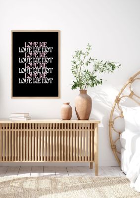 An unframed print of love me love me not in typography in pink and black accent colour