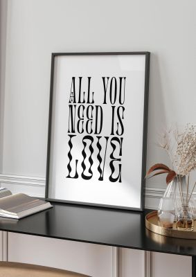 An unframed print of all you need is love lyric white in typography in white and black accent colour