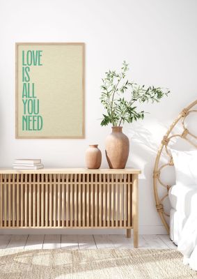 An unframed print of love is all you need in typography in beige and green accent colour